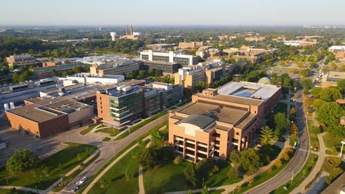 Michigan State University complex buildings on sunny day, aerial view