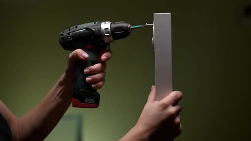 Woman Securing Screw With Power Drill for Home Improvement