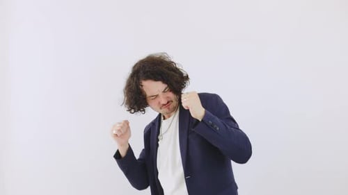 Man Dancing Joyfully in a White Studio