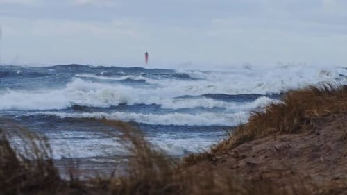Powerful sea storm with waves engulfing Mangalsala lighthouse - Riga Latvia