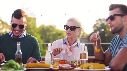 Friends Enjoying Food and Conversation on Patio