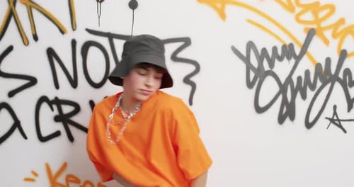 Teen Girl Walks In Front of Graffiti Wall