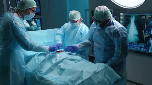 Team of Professional Medical Surgeons Performs the Surgical Operation in a Modern Hospital Doctors