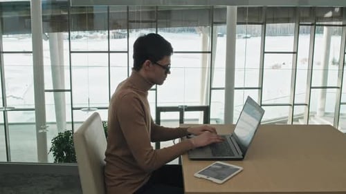 Businessman Working on Computer in Modern Office