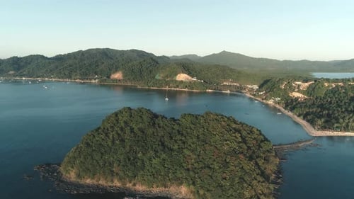Aerial Drone Flight Over Island Covered with Tropical Forest on Sunset Time Tropical Paradise Bay