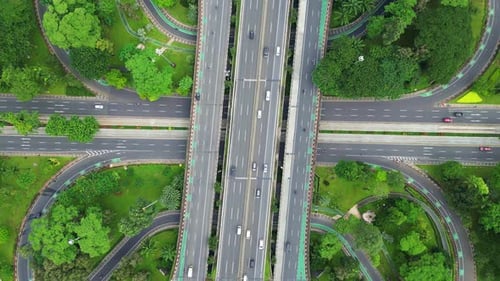 A freeway with a large bridge over it and a city in the background