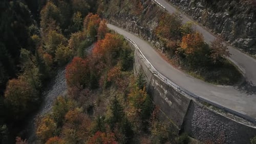 Hairpins of Plateau des Glières in Haute-Savoie during autumnal foliage, France. Aerial top-down for