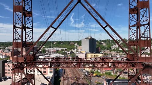 An aerial view of the Norwalk River Railroad Bridge on a sunny morning. The drone camera dolly out f