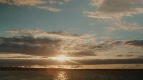 Ocean Sunrise with Dramatic Clouds and Golden Light