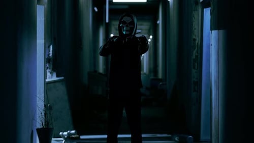 Sinister Masked Figure with Gun in Dark Hallway