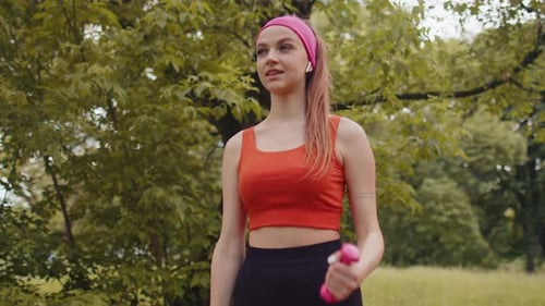 Athletic Young Sporty Fit Girl Doing Dumbbells Workout in Sunny Park Performing Bicep Exercising