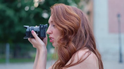Close Up Profile of a a Beauty Woman Taking a Photo Outdoors