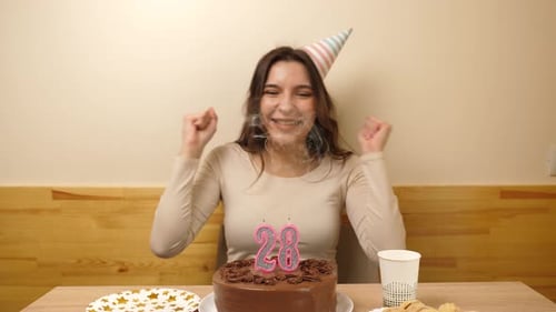 Woman Celebrates Birthday by Blowing Out Candles