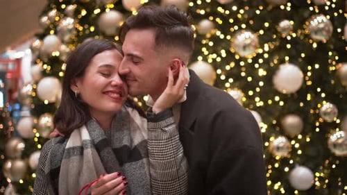 Romantic Couple Embraces at Christmas Time