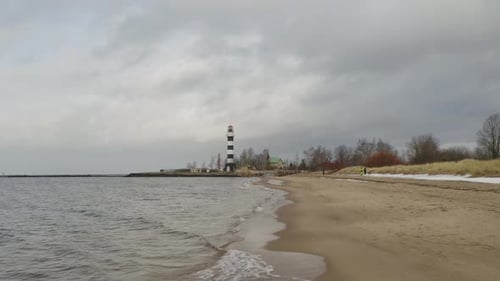 Flying very low at the beach. Small waves hitting the coast.