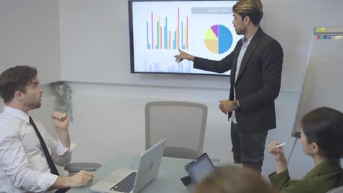 Corporate Meeting with Data Presentation in Modern Office