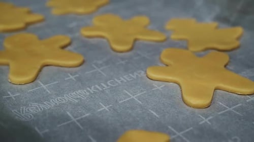 Close up panning over Christmas Holiday shaped sugar cookie dough on a baking sheet pan ready to go