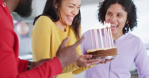 Friends Celebrating Birthday with Cake and Candles