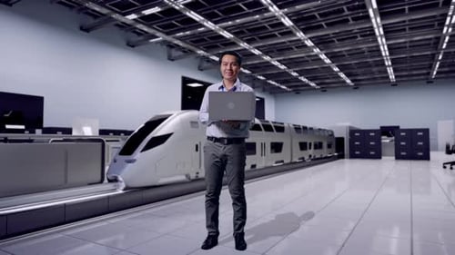 Man Holding Laptop Stands by Futuristic Train