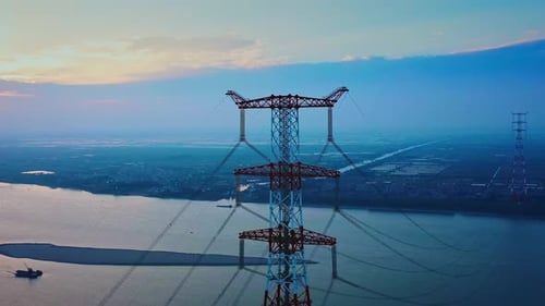 Aerial View of Powerlines and River at Sunset