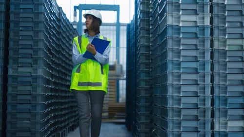 Focused Storekeeper Checking Boxes Analysing Pallets Before Shipping Delivery. Female Storehouse Spe