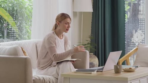 Woman on Couch Talking During a Video Call