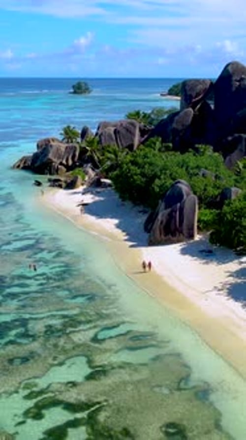 Couple on the Beach of Anse Source D'Argent the Most Beautiful Beach of Seychelles