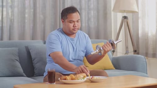 Man Works Out and Eats Fast Food at Home