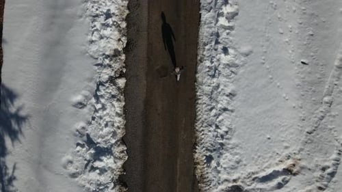 Man Walking on Snowy Way