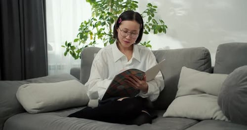 Young Woman Studying and Writing in Notebook