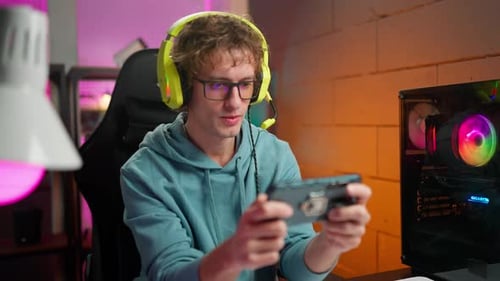 Young Adult Plays Game on Smartphone