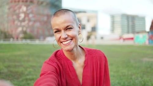 Smiling Woman Making Peace Sign Outdoors