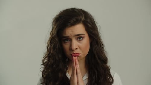 Young Woman Looking Pleadingly at Camera