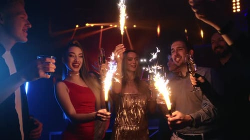 Happy Friends Celebrate Holiday Sparkles Lights Cheers Champagne Christmas Night Club Disco Party