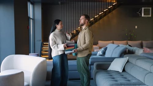 Man and Woman Looking at Fabric Samples in Store
