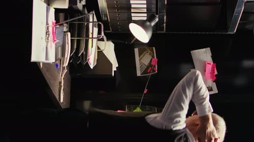 Man working at cluttered desk in office