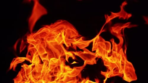 Top part of the bonfire burning in the darkness. Beautiful fire flames dancing in the night.