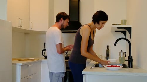 Man and Woman Preparing Food in Kitchen at Home