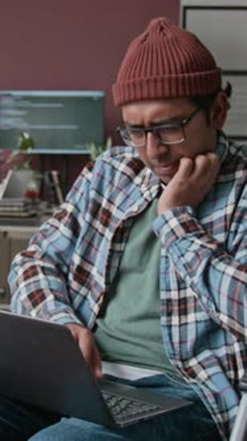 Geeky Indian Male Programmer Working on Code in Office