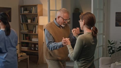 Senior Couple Dancing Together in Home Living Room