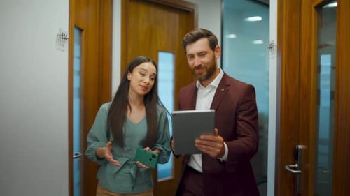 Woman and Man Video Call in Office Hallway