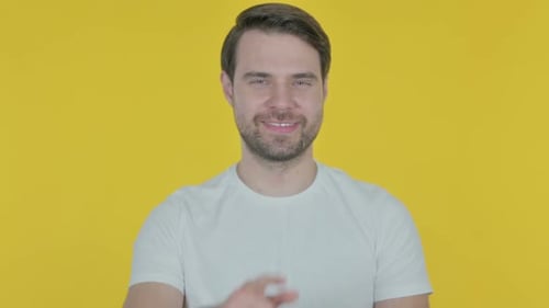 Young Man Pointing at the Camera on Yellow Background