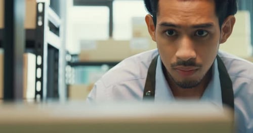 man wear formal shirt hold digital tablet check inventory online stock data in cardboard box.