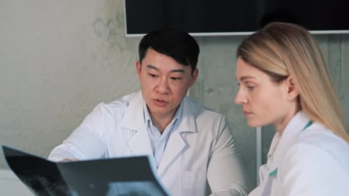 Doctors Analyzing X-Ray Images in Bright Office