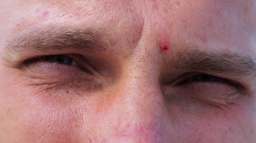 Close Up to Upset Male Face Looking Into Camera with a Disappointing Sight Upset Facial Expression