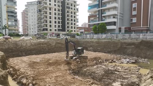 Excavator Digging on Construction Site in City