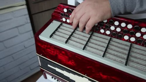 Repairing a Red Accordion with a Screwdriver
