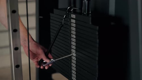 Hand Setting Weight on Gym Machine