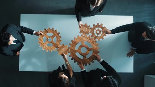 Top view of business team bring filled last cog to complete system. Directorate.