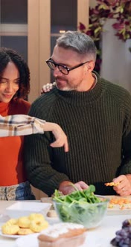 Multi-generational Family Preparing Thanksgiving Dinner in Kitchen